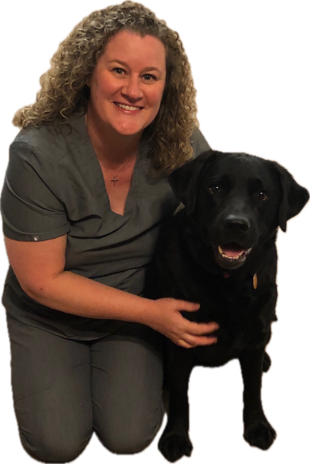 Jesica Golightly, owner of Cozi Paws, kneeling beside a black Labrador